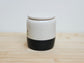 White and black ceramic container with personalised name engraved. 