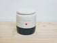 Custom pet urn with black base and 'Flynn' and handpainted heart design. This is a hand thrown personalised urn.