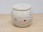 Ceramic urn with 'Bella Rose' and personalized text on a wooden surface