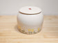 Custom daisy flower pet urn for dog or cat ashes, handcrafted pottery keepsake with ladybug design