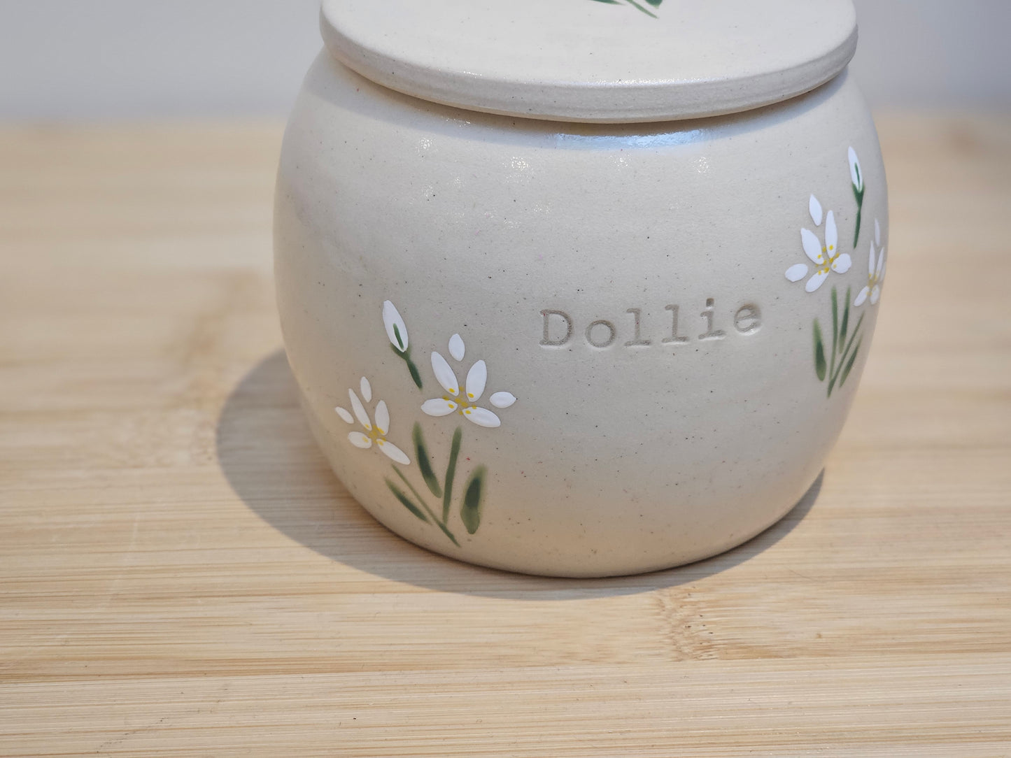 Custom pet cremation urn with white lilies, elegant floral tribute for dogs or cats