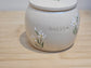 Custom pet cremation urn with white lilies, elegant floral tribute for dogs or cats