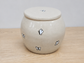 Keepsake urn with butterfly designs on a wooden surface
